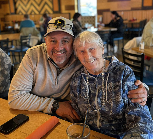 Scott-Ganton-and-resident-outing Scott Ganton and a female resident of Lakeview Assisted living, smiling an posing for a photo while on a community outing to a restaurant.