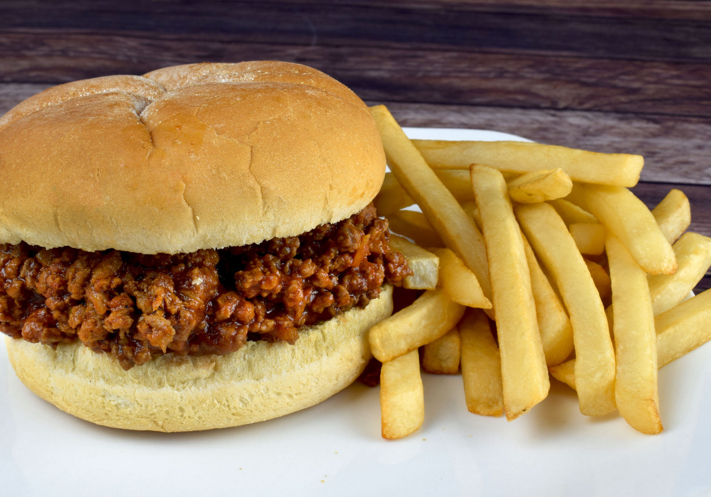sloppy joe  with fries on a plate